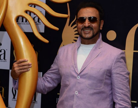 Gulshan Grover in White High Neck T-Shirt with Dark Jeans Goggles Cool Look at IIFA 2015 Press Meet